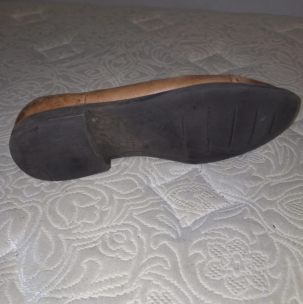 A pair of Cole Haan Oxfords in a men's size 12M. Pre-loved in good condition.